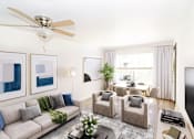 Thumbnail 2 of 13 - a living room with a couch and chairs and a table