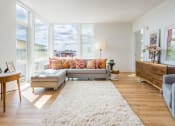 Thumbnail 4 of 27 - a living room with a gray couch and a white rug