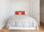 Thumbnail 5 of 27 - a bedroom with a bed and white walls