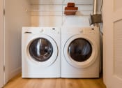 Thumbnail 9 of 27 - a washer and dryer sit side by side in a laundry room