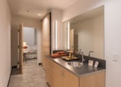 Thumbnail 6 of 27 - a bathroom with a sink and a mirror