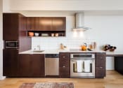 Thumbnail 1 of 27 - a kitchen with dark wood cabinets and white countertops