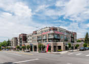 Thumbnail 20 of 48 - a large brick building with a red and white sign on the side of it