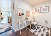 Thumbnail 5 of 48 - a white desk with a white chair and a white ladder shelf with books and a lamp