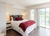 Thumbnail 7 of 48 - a bedroom with a bed and a sliding glass door