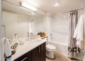 Thumbnail 9 of 48 - a bathroom with a shower toilet and sink