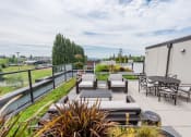 Thumbnail 10 of 48 - a roof terrace with a table and chairs and a firepit