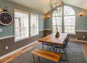 Thumbnail 20 of 20 - a dining room with a large window and a wooden table