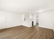 Thumbnail 31 of 49 - A room with wooden floors and white walls.