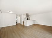 Thumbnail 24 of 49 - A room with wooden floors and white walls.