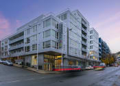 Thumbnail 19 of 22 - a large grey building on a city street