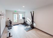 Thumbnail 15 of 24 - a workout room with a treadmill and other equipment in a home
