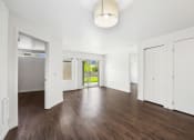 Thumbnail 32 of 48 - an empty living room with white walls and wood floors