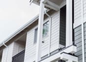 Thumbnail 20 of 24 - a white house with white siding and a window