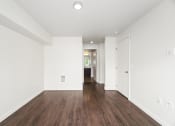 Thumbnail 38 of 48 - a living room with white walls and wood floors