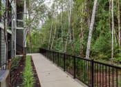 Thumbnail 22 of 24 - a balcony with a view of a forest and a house