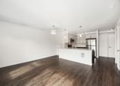 Thumbnail 40 of 48 - a living room and kitchen with wood floors and white walls