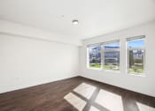 Thumbnail 36 of 48 - a living room with white walls and wood floors