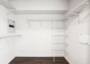 Thumbnail 42 of 48 - a walk in closet with white walls and white shelves and a white walled closet