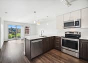 Thumbnail 33 of 48 - a modern kitchen with stainless steel appliances and white cabinets