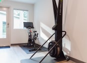Thumbnail 13 of 24 - a home gym with exercise equipment in a white room
