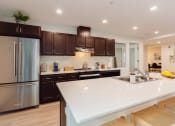 Thumbnail 9 of 24 - a large white counter top in a kitchen with stainless steel appliances