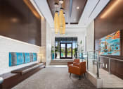 Thumbnail 23 of 48 - a lobby with a seating area and a glass door