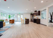 Thumbnail 7 of 24 - a living room with a kitchen and a dining room