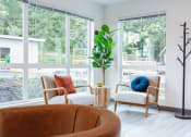 Thumbnail 11 of 24 - a living room with two chairs and a large window