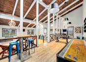 Thumbnail 10 of 49 - a games room with a shuffleboard table and a ping pong table