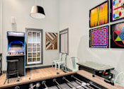 Thumbnail 9 of 49 - a room with a piano and a table with chairs and a video game on a