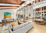 Thumbnail 7 of 49 - a living room with a couch and tables and chairs