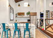 Thumbnail 8 of 49 - a kitchen with blue chairs and a marble counter top