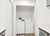 Thumbnail 9 of 25 - a white laundry room with a washer and dryer in it