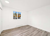 Thumbnail 6 of 25 - an empty room with white walls and a window