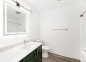 Thumbnail 8 of 25 - a bathroom with a sink and a toilet and a mirror