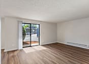 Thumbnail 20 of 29 - A room with a sliding glass door leading to a street.