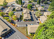 Thumbnail 10 of 29 - A bird's eye view of a residential area with houses and a parking lot.