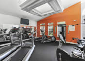 Thumbnail 15 of 29 - a gym with treadmills and other exercise equipment
