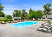 Thumbnail 11 of 22 - our resort style swimming pool is surrounded by lounge chairs and trees
