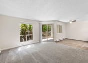 Thumbnail 8 of 22 - an empty living room with a ceiling fan and a window