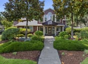 Thumbnail 18 of 26 - the front of a house with a walkway and trees