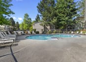Thumbnail 19 of 26 - a resort style pool with chairs around it and trees
