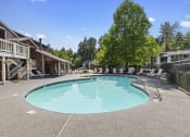 Thumbnail 23 of 26 - the resort style pool is surrounded by buildings and trees