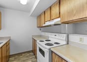 Thumbnail 5 of 26 - a kitchen with white appliances and wood cabinets