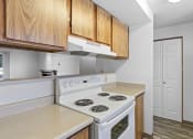 Thumbnail 3 of 26 - a kitchen with white appliances and wooden cabinets and a white refrigerator