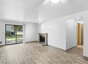 Thumbnail 1 of 26 - a living room with a fireplace and a sliding glass door