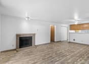 Thumbnail 4 of 26 - a living room with a fireplace and a wooden floor