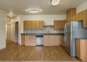 Thumbnail 9 of 20 - a kitchen with wooden cabinets and stainless steel appliances