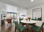 Thumbnail 3 of 33 - a living room and dining room with green chairs and a white table